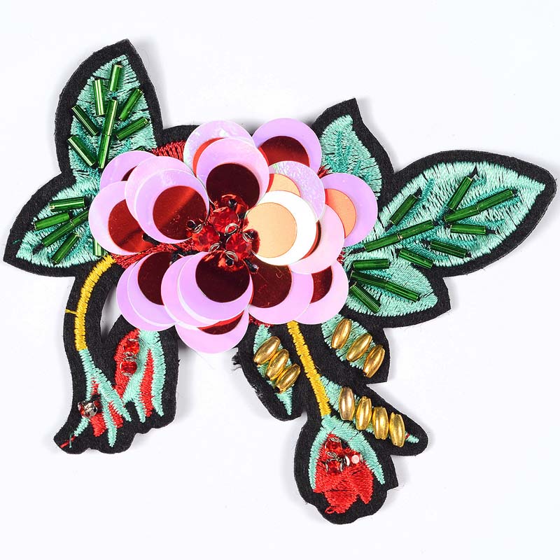 Custom handmade floral patch featuring pink and red layers of sequins, red crystal centers, and green tube beaded leaves.